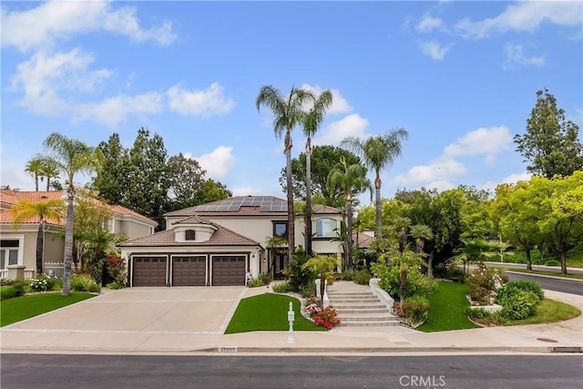 25605 Queenscliff Ct, Calabasas, CA 91302 - view of front of house with a garage, driveway, solar panels, stucco siding, and a tiled roof