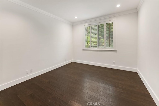 spare room with baseboards, recessed lighting, ornamental molding, and dark wood-style flooring