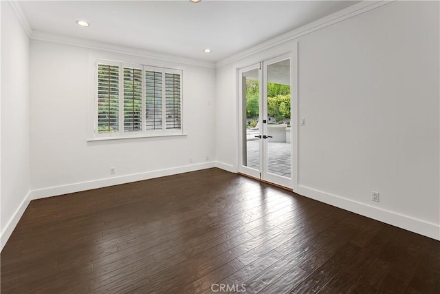 unfurnished room featuring baseboards, dark wood-style flooring, and crown molding