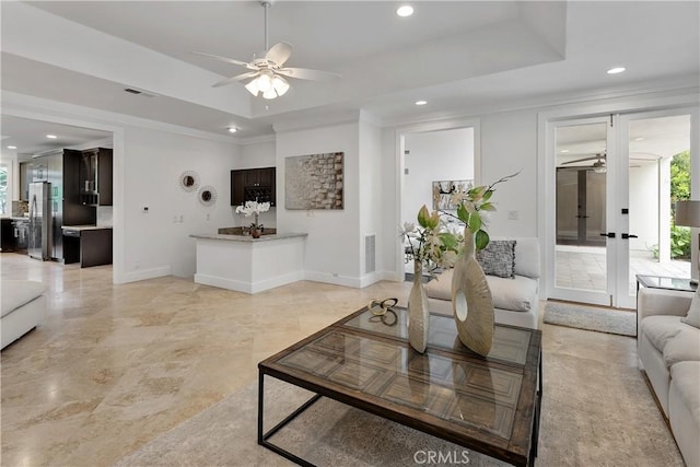 living room with recessed lighting, a raised ceiling, visible vents, and ceiling fan