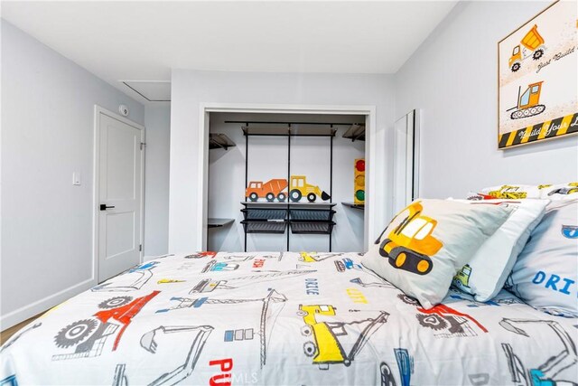 bedroom featuring a closet and baseboards