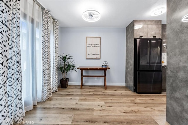 interior space with light wood-type flooring and baseboards