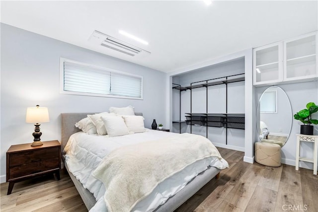 bedroom featuring baseboards and wood finished floors