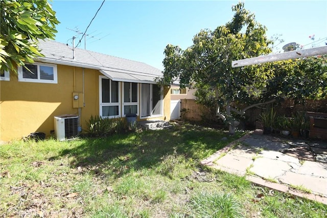 view of yard featuring central air condition unit and fence