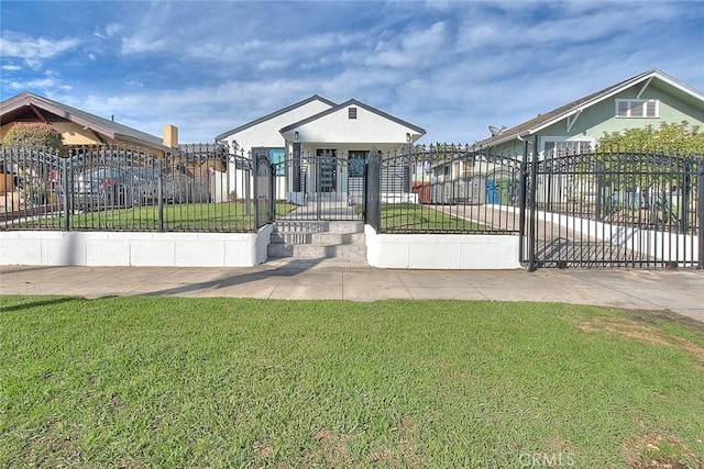 view of front of house featuring a fenced front yard, stucco siding, a front lawn, and a gate