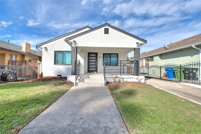 view of front of house featuring a gate, fence, covered porch, and stucco siding