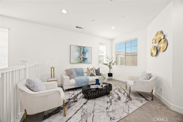 living area with baseboards, visible vents, and recessed lighting