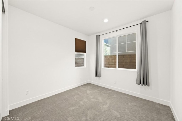 spare room with baseboards, carpet flooring, and recessed lighting