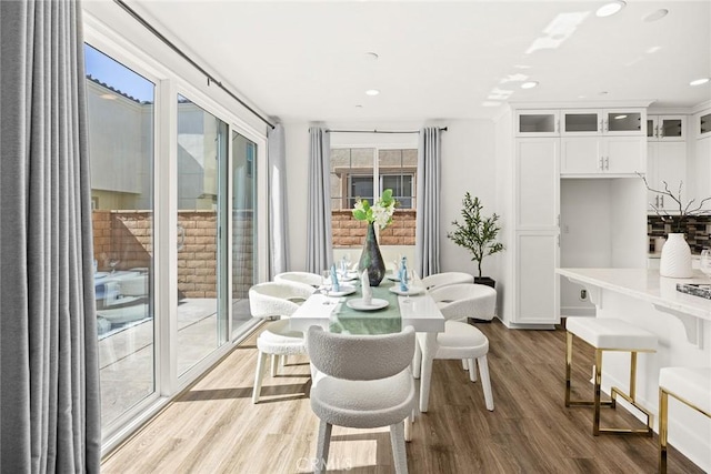 dining room with light wood finished floors and recessed lighting