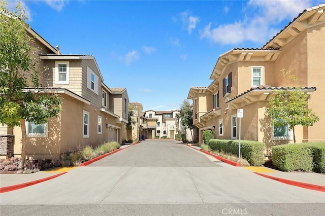 view of street featuring curbs, sidewalks, and a residential view