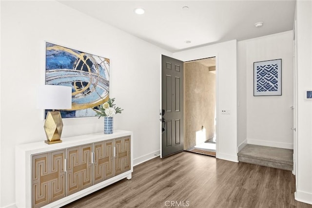 foyer with baseboards, wood finished floors, and recessed lighting