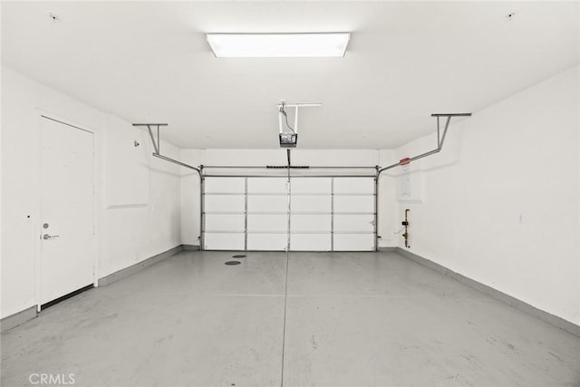 garage featuring baseboards and a garage door opener