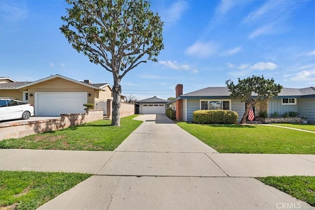 ranch-style house with a garage, fence, a front lawn, and an outbuilding