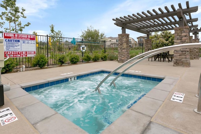 view of pool with a hot tub, fence, and a pergola