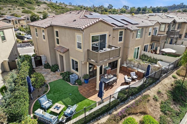 rear view of house featuring a fenced backyard, an outdoor hangout area, a tile roof, a residential view, and stucco siding