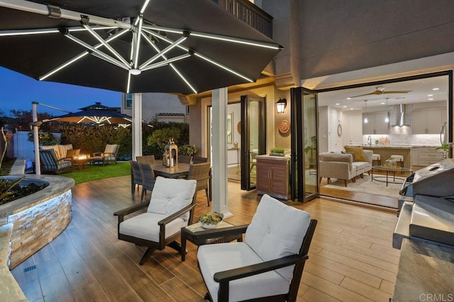 view of patio featuring outdoor dining area, outdoor lounge area, and a wooden deck