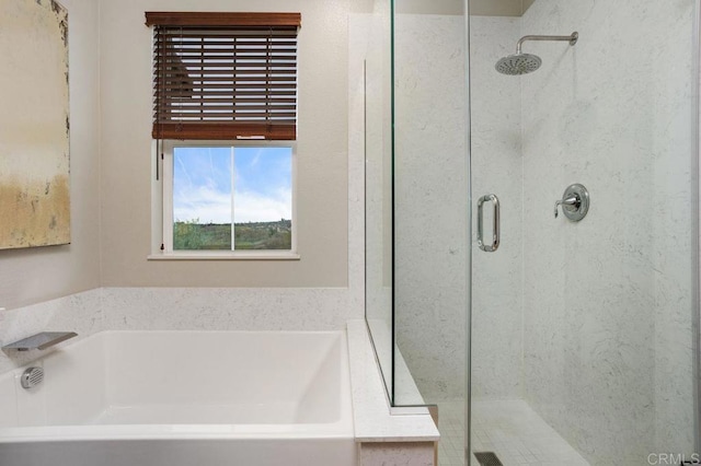 full bathroom with a garden tub and a shower stall