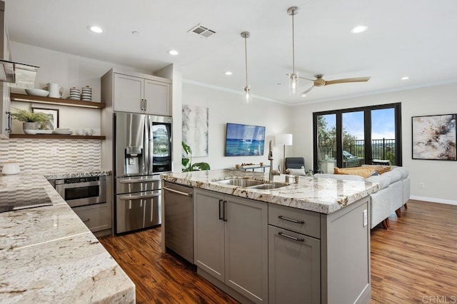 kitchen with stainless steel appliances, ornamental molding, gray cabinets, and open shelves