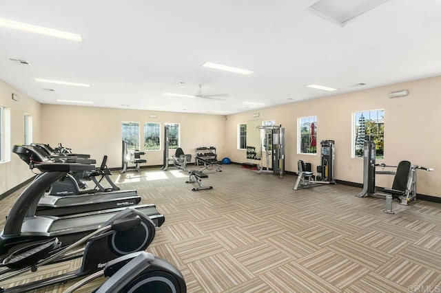 exercise room with a ceiling fan, carpet flooring, visible vents, and baseboards