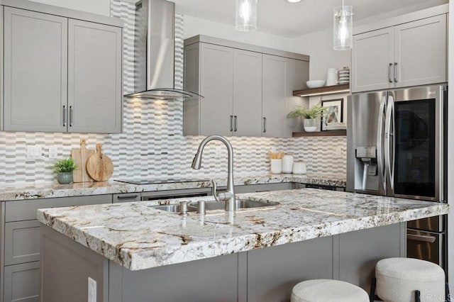 kitchen featuring open shelves, wall chimney range hood, stainless steel refrigerator with ice dispenser, and gray cabinets