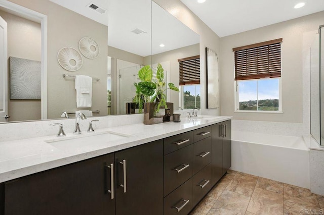 full bath with double vanity, visible vents, a sink, and a bath