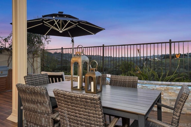 patio terrace at dusk featuring outdoor dining area