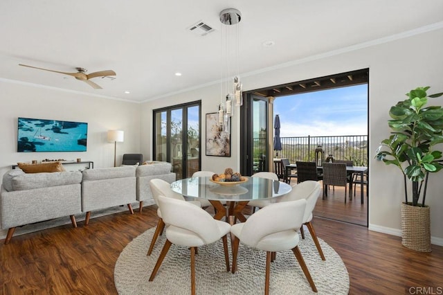 dining space with dark wood-style floors, visible vents, and a healthy amount of sunlight