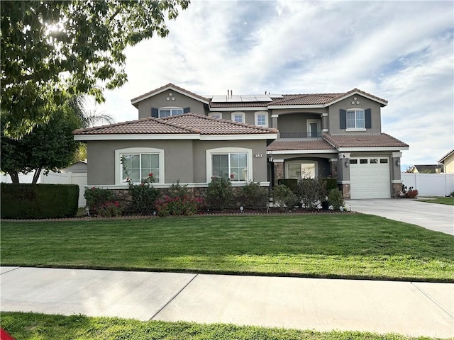 view of front of property with solar panels, fence, stone siding, driveway, and a front yard