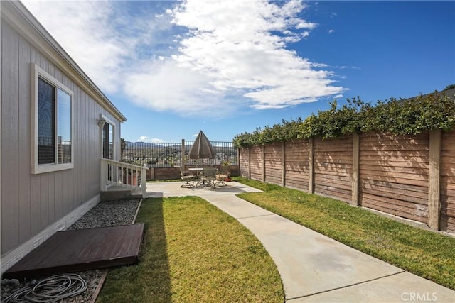 view of yard with a patio area and a fenced backyard