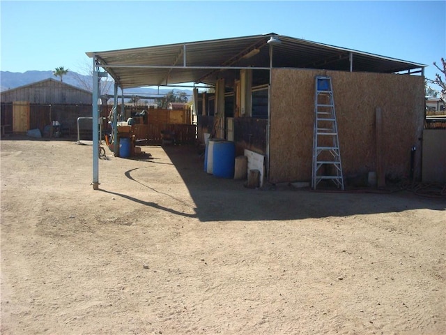 back of property featuring an exterior structure and an outdoor structure