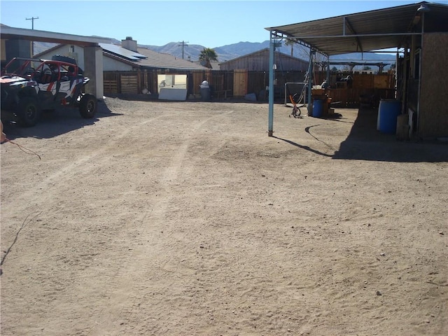 view of yard with fence and a mountain view