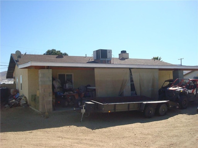 rear view of house featuring central air condition unit