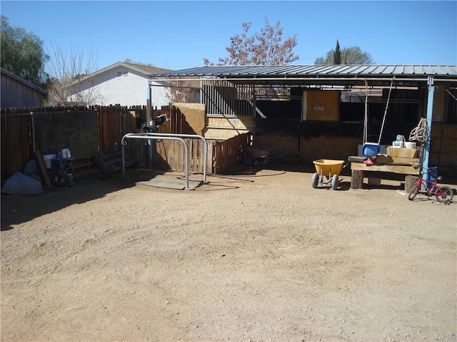 back of property featuring metal roof, an outdoor structure, and an exterior structure