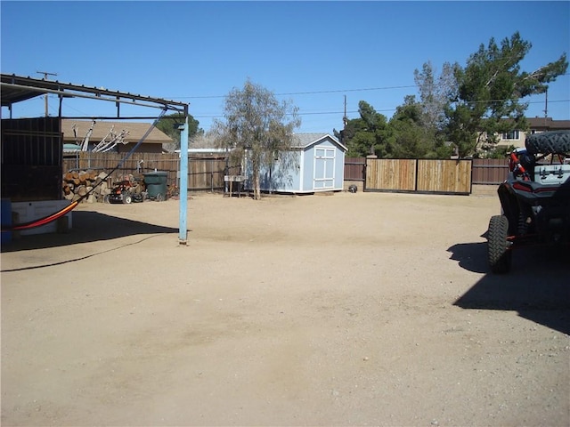 view of yard with an outbuilding, fence, and a storage unit