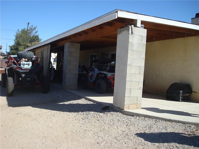 view of vehicle parking with a carport