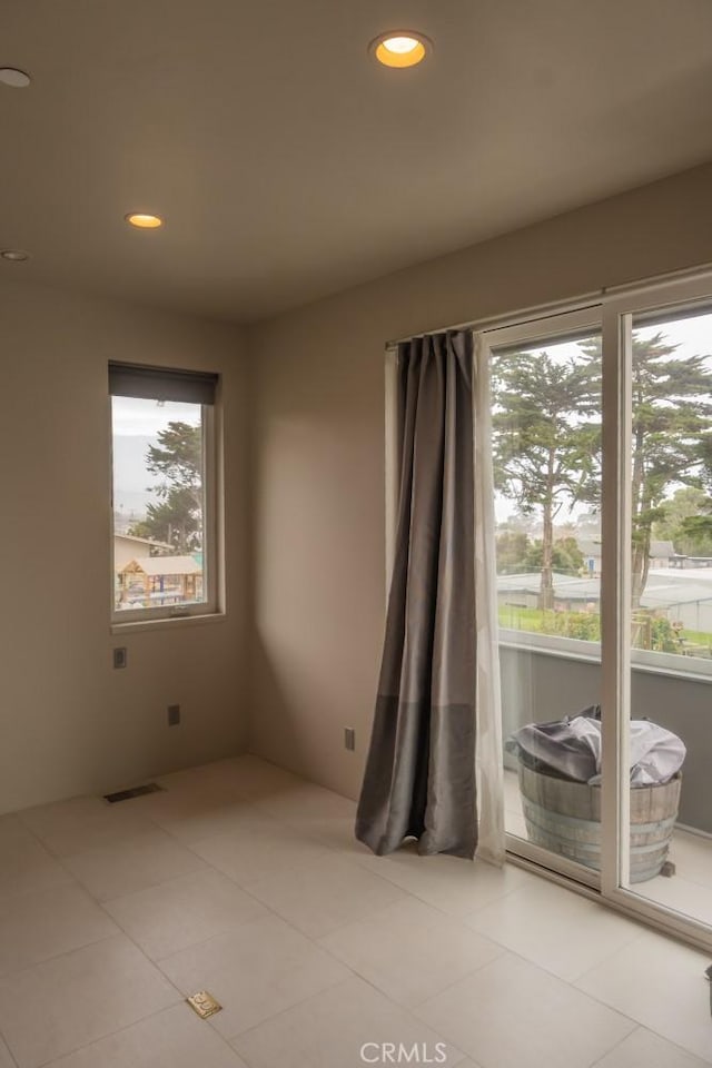 spare room with recessed lighting, visible vents, and light tile patterned floors