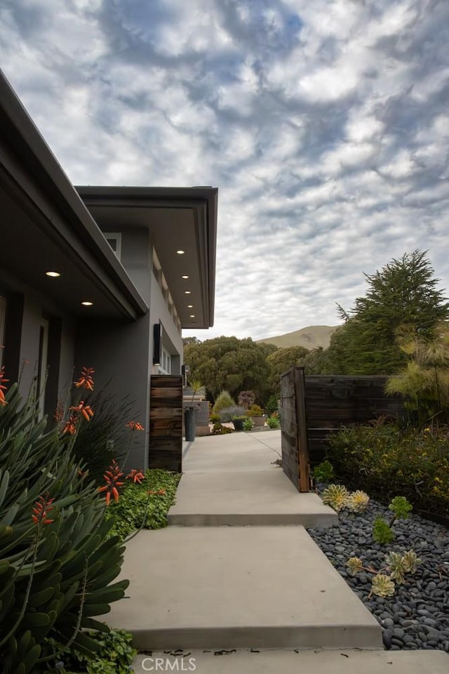 exterior space featuring a mountain view and stucco siding