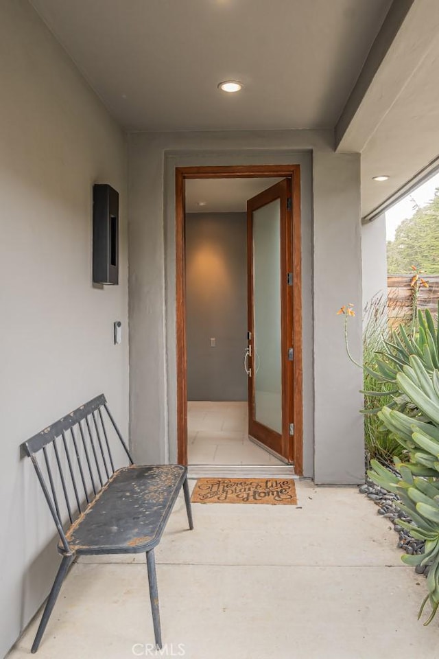 doorway to property featuring stucco siding