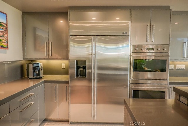 kitchen with appliances with stainless steel finishes and gray cabinetry