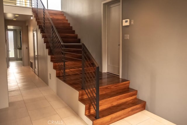 stairs with tile patterned floors