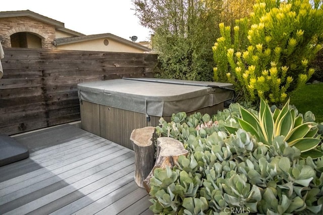 wooden deck with a hot tub