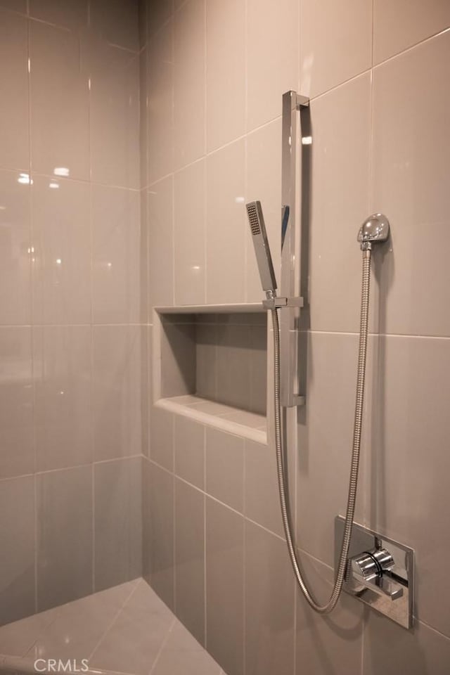 full bathroom with tiled shower