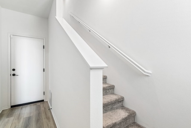 staircase with wood finished floors