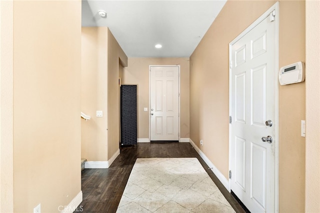 hall with dark wood-type flooring, recessed lighting, and baseboards