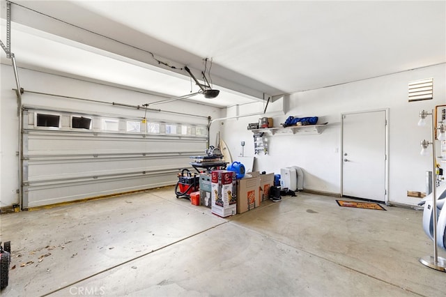 garage with baseboards and a garage door opener