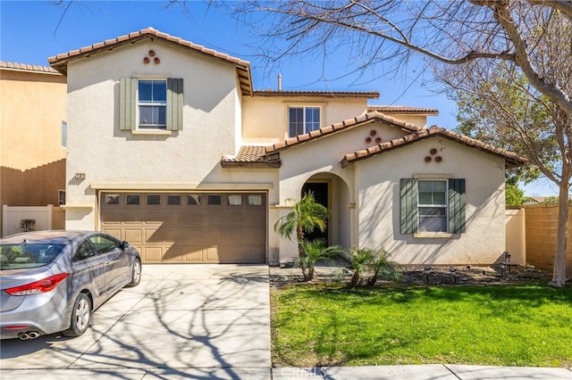 mediterranean / spanish home featuring fence, driveway, and stucco siding