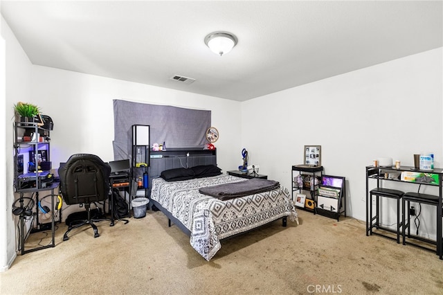 carpeted bedroom featuring visible vents