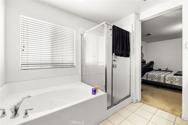 ensuite bathroom with a garden tub, visible vents, a shower stall, tile patterned floors, and ensuite bath