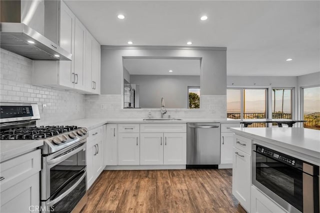 15470 Longbow, Sherman Oaks, CA 91403 - kitchen with light countertops, wall chimney exhaust hood, tasteful backsplash, a sink, and stainless steel appliances