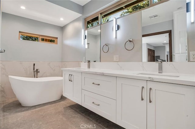 15470 Longbow, Sherman Oaks, CA 91403 - bathroom with a sink, a soaking tub, wainscoting, and double vanity